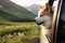 A canine friend, the Akita Inu, happily watches the world go by from the car window during a summer getaway