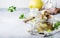 Canned artichokes in olive oil, in glass jar with fork, gray kitchen table background, selective focus