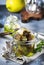 Canned artichokes in olive oil, in glass jar with fork, gray kitchen table background, selective focus