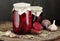 Canned beetroot in glass jars on rustic wooden background, closeup, food storage solution