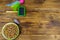 Canned cat food in bowl, cat toys and pet slicker brush on wooden background. Top view, copy space. Pet care concept