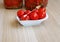 Canned cherry tomatoes in a small plate with a decorative fork