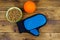 Canned dog food in bowl, ball toy and pet grooming glove on wooden background. Top view. Pet care concept
