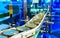 Canned food products on conveyor belt in distribution warehouse.