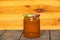 Canned jar with sea buckthorn jam on a wooden table