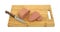 Canned meat on cutting board with knife