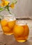 Canned natural peaches in glass jars with compote