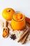 Canned organic pumpkin puree in glass jar with fresh pumpkin, cinnamon and anise on light stone background. Ingredient for