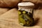 Canned pickles in a glass jar twisted with a rope