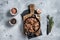 Canned stewed horse and beef meat in a pan. Gray background. Top view