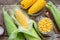 Canned sweet corn in glass jar, fresh and cooked corn on cobs, salt.