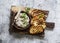 Canned tuna, cream cheese, herb pate and grilled bread on a cutting Board, top view. Delicious tapas, appetizer, snack