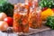 Canned vegetable salad in glass jars and ingredients for homemade