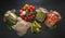 Canned vegetables cucumber and tomato in bowl and glass jars on dark wooden board. Banner. Still life. View from above