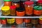 Canned vegetables and jams on refrigerator shelves