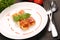 Cannelloni on the plate on a wooden background