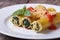 Cannelloni stuffed with spinach and cheese with tomato sauce