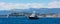 Cannes seafront panorama with Alpes rocky cliffs, port, old town and yacht sailing on waters of Mediterranean Sea in France