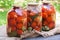 Canning tomatoes in glass jars with spices