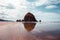 Cannon Beach, Oregon coast: the famous Haystack Rock reflects itself in the water