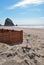 Cannon Beach, Oregon with a rainbow colored windmill in the sand