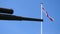 Cannon and flag of England against blue sky