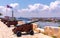 Cannons at Fort of Saint Charles, cuban flag and cruise ship in Havana