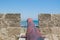 Cannons on the wall of  Medieval Castle of Larnaca Fort and blue sea in Cyprus