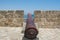 Cannons on the wall of  Medieval Castle of Larnaca Fort and blue sea in Cyprus