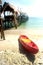 Canoe on the beach near traditional wooden bridge.