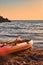 Canoe on a beach next to the water