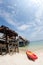 Canoe on the beach and traditional wooden bridge.