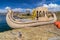 Canoe boat at Uros floating island and village on Lake Titicaca near Puno, Peru