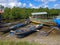 Canoe boats lined up on the edge of the estuary.