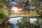 Canoe boats near a river, sunrise in background.