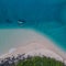 Canoe cruising through the blue water and sand banks