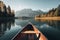 Canoe floating on a serene mountain lake surrounded by tall pine trees on a peaceful morning