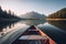 Canoe floating on a serene mountain lake surrounded by tall pine trees on a peaceful morning