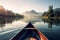 Canoe floating on a serene mountain lake surrounded by tall pine trees on a peaceful morning