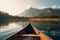 Canoe floating on a serene mountain lake surrounded by tall pine trees on a peaceful morning