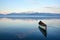 canoe floating on tranquil lake with distant mountains