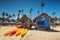 Canoe Kayak boats on sunny tropical beach with palm trees