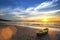 Canoe on the ocean beach during the amazing sunset.