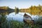 Canoe with paddle on shore of beautiful lake with island in northern Minnesota at dawn