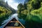 A canoe paddling down a river. View from canoe the front part.