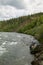 Canoe and raging rapids on an Alaskan river