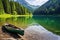 a canoe resting on the shore of a serene alpine lake