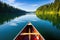 canoe slicing through tranquil waters of a scenic lake