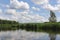 Canoeing in a kayak on Czarna Hancza virgin river in north-eastern Poland with blue sky, white clouds and green treas on a sunny s