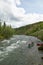 Canoeing on river rapids in wild, remote Alaska